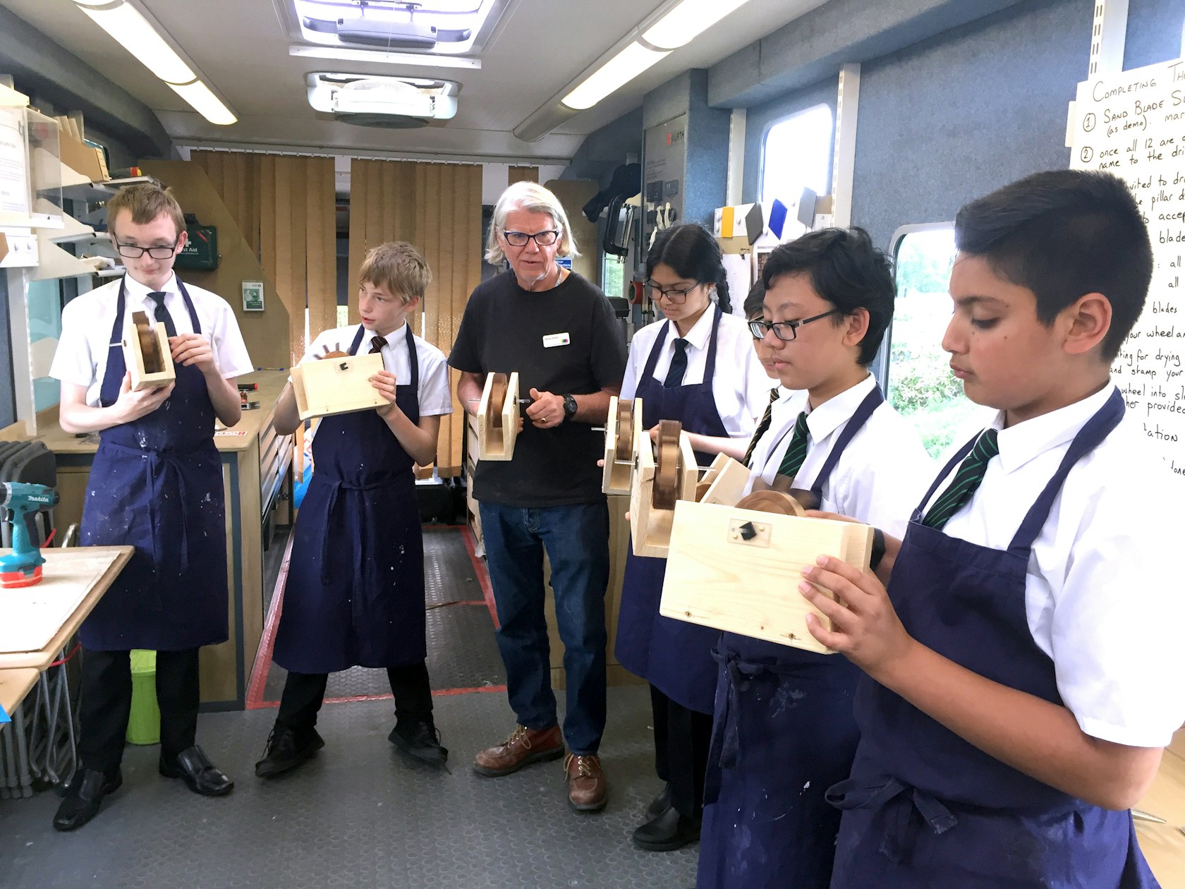 Derby Moor Academy students hold the water wheels they made as part of a workshop session on The Makory – photo Derby Museums alt
