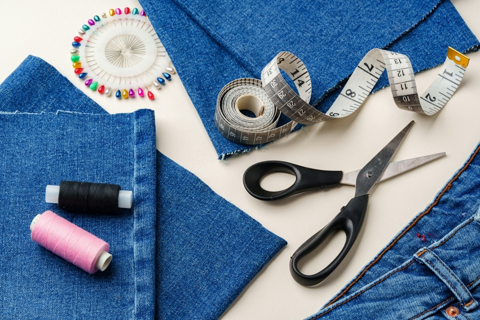 Sewing,Supplies,And,Denim,Fabric,Arranged,On,A,Workspace,For